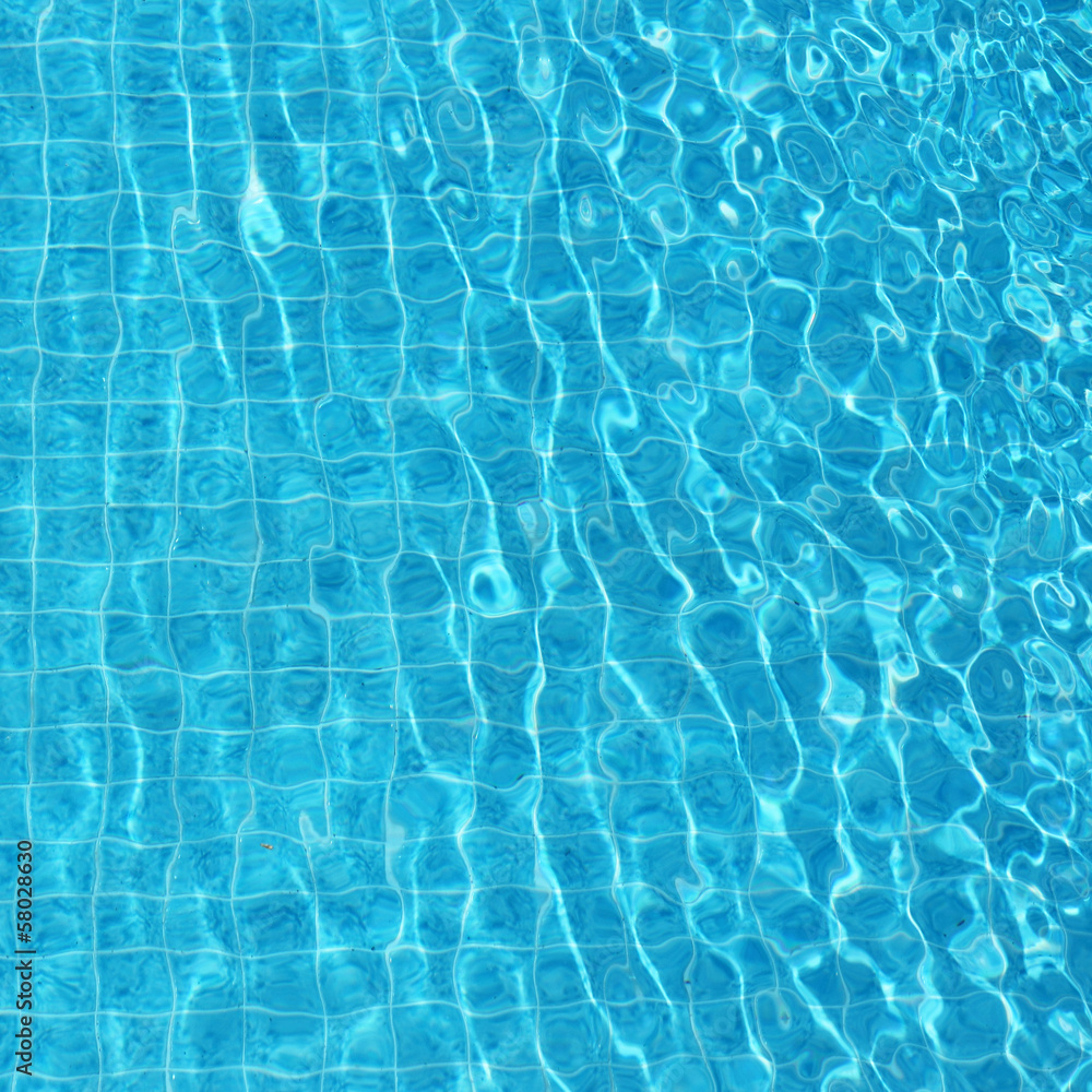 Blue rippled water background in swimming pool