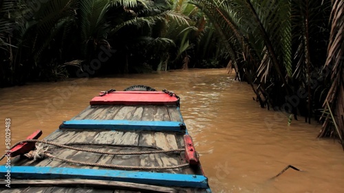 Boat on a canal in Mekong delta, Vietnam photo