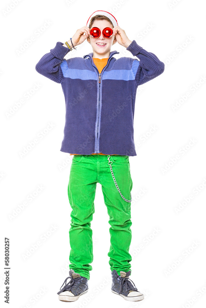 funny teenager boy holding two red christmas balls  before his e