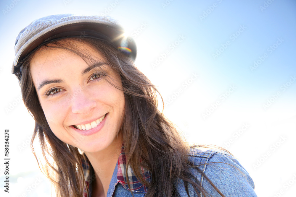 Portrait of woman with hat on a sunny day