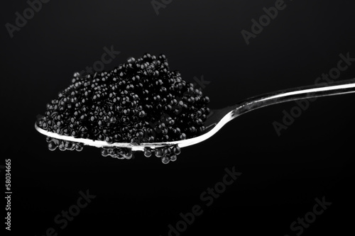 Black caviar in metal spoon