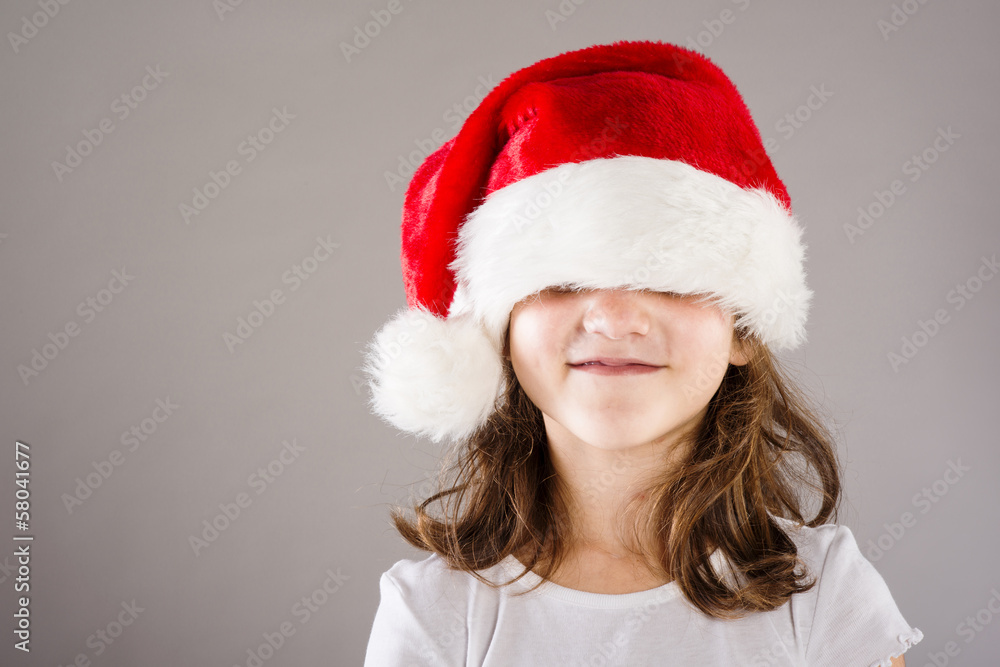 Small girl in santa hat with christmas gift Small girl in santa hat with christmas gift
