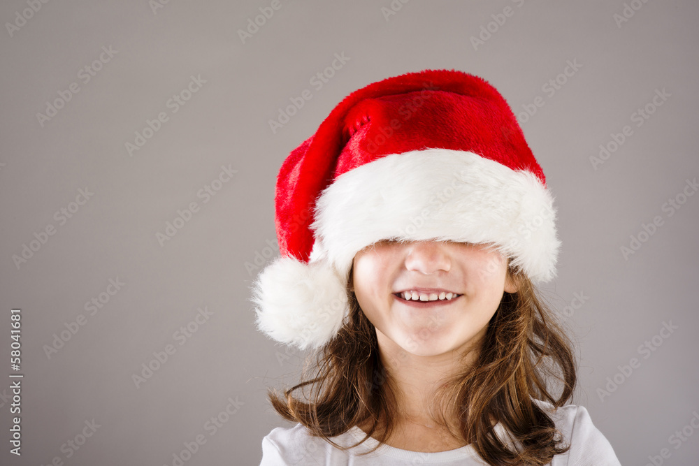 Small girl in santa hat with christmas gift Small girl in santa hat with christmas gift