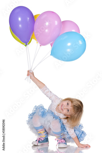 Cheerful little girl with balloons