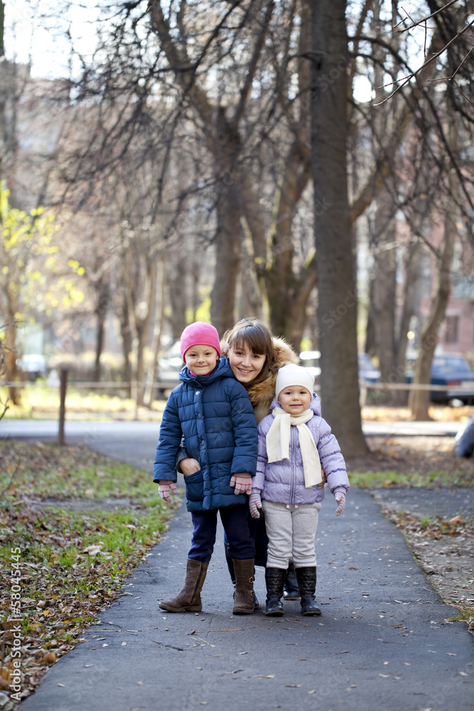 Fototapeta premium Mother and her little girls outdoors session