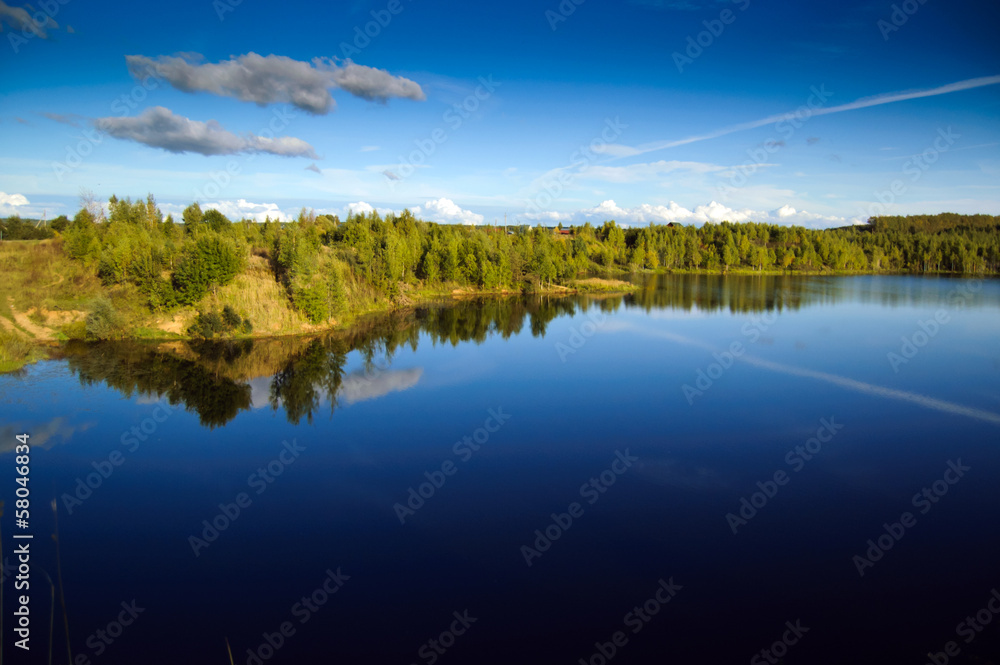 Landscape with blue sky and smooth lake surface