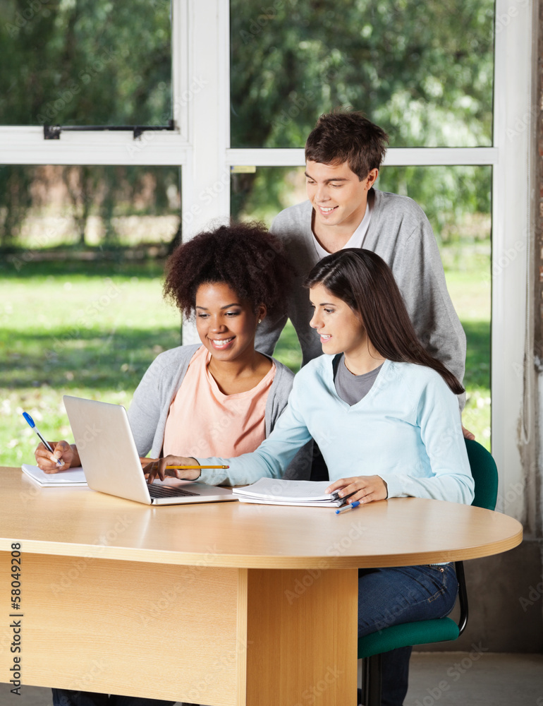 Students With Laptop Studying Together In Classroom Students With Laptop Studying Together In Classroom