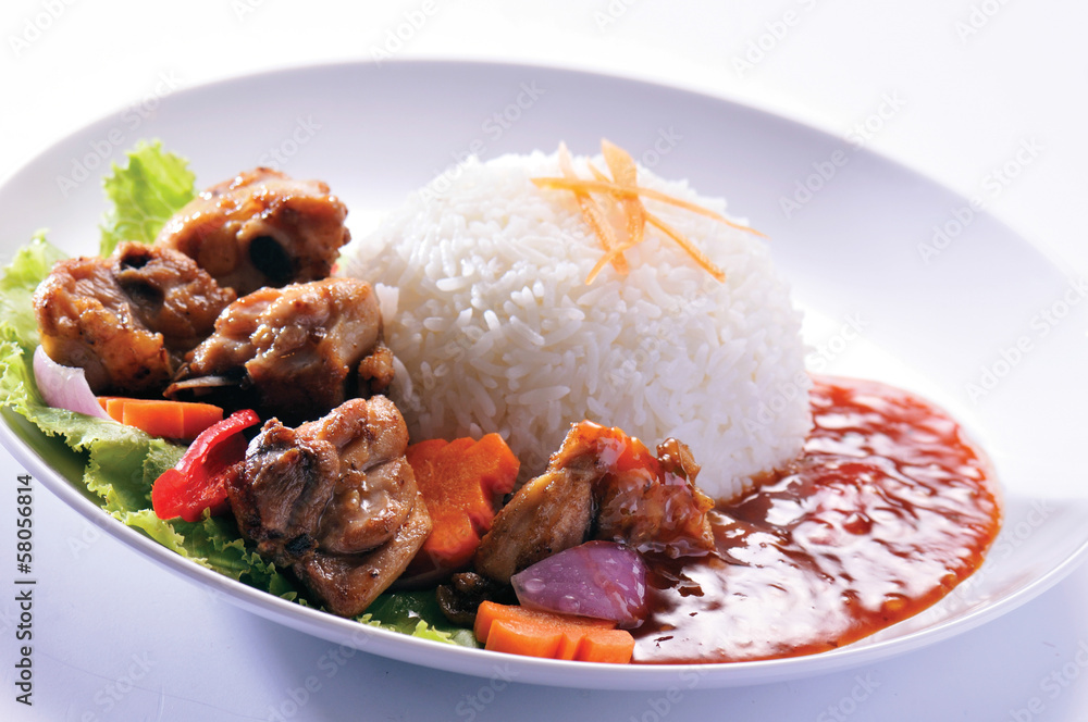 Chicken with rice and vegetables in background Chicken with rice and vegetables in background