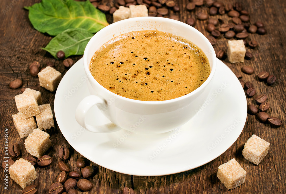 Obraz premium coffee on a wooden background with beans and cane sugar