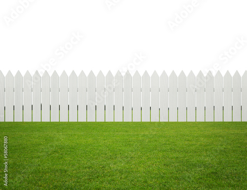 Tableau sur toile Front or back yard, white wooden fence on the grass