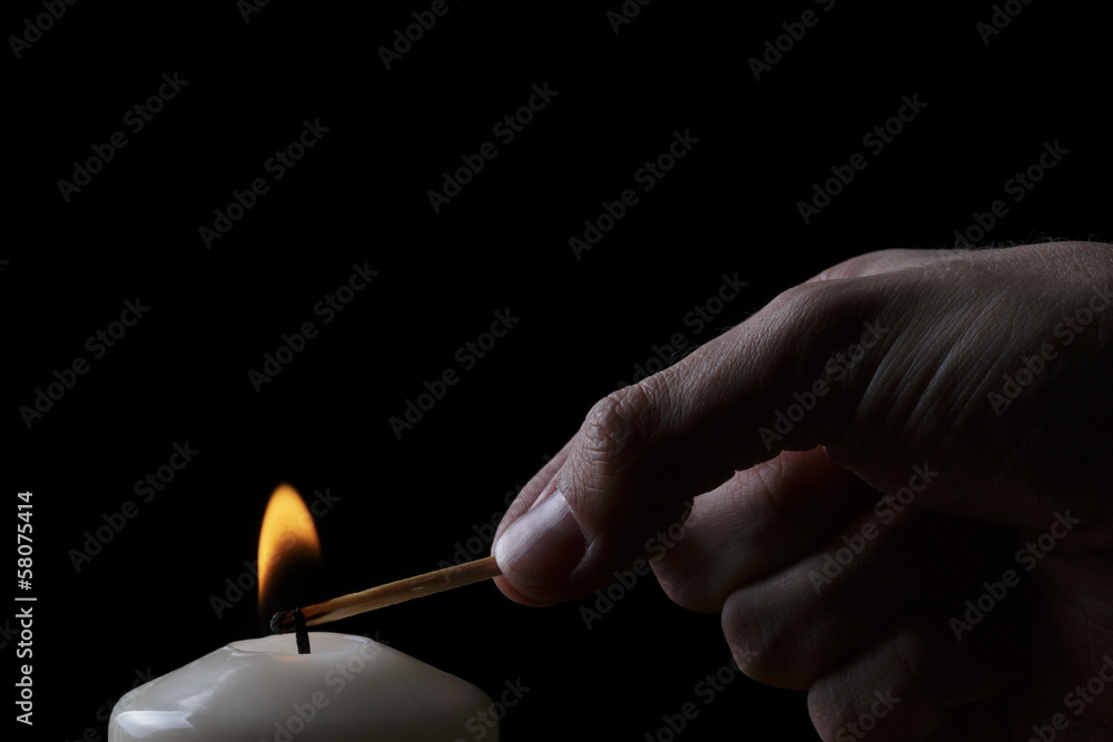 adult man hand set fire a candle adult man hand set fire a candle