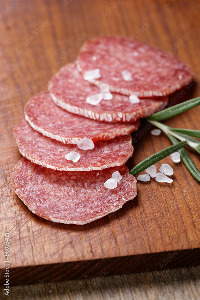 italian salami sausage slices with rosemary and sea salt