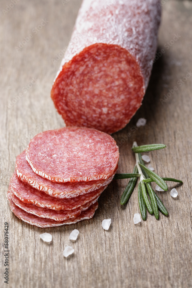 italian salami sausage slices with rosemary and sea salt italian salami sausage slices with rosemary and sea salt