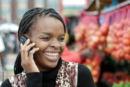 Fotografie African or black American woman calling on mobile cellphone