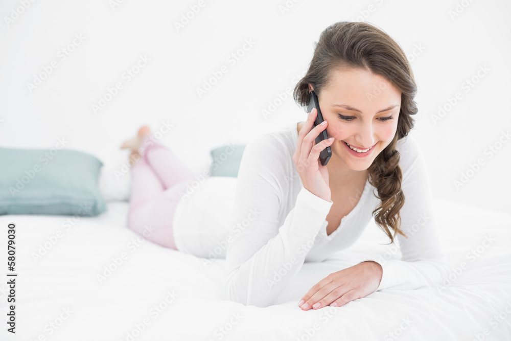 Beautiful woman using mobile phone in bed Beautiful woman using mobile phone in bed