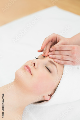Hands massaging a beautiful woman s forehead