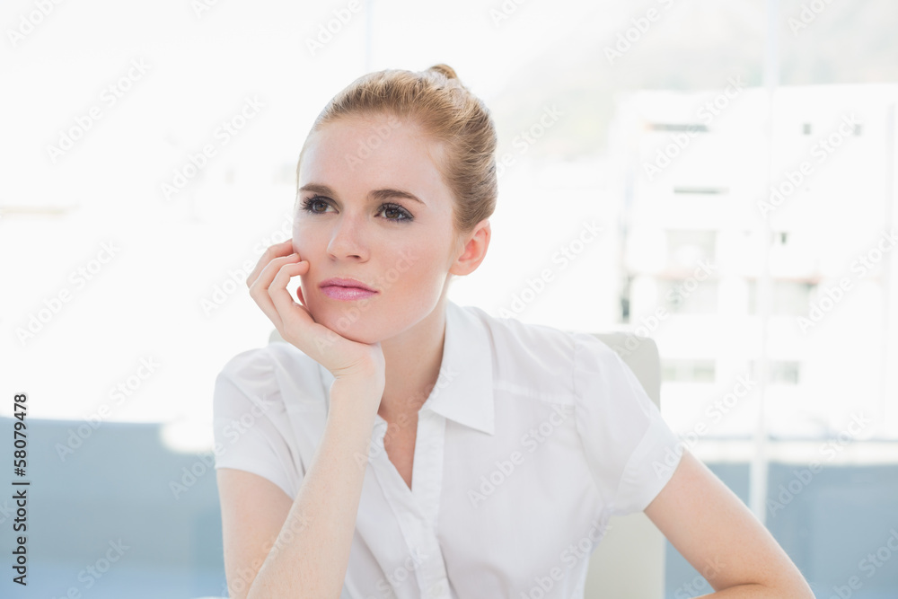 Thoughtful businesswoman looking away in office Thoughtful businesswoman looking away in office