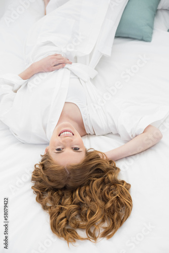 Overhead portrait of pretty woman resting in bed
