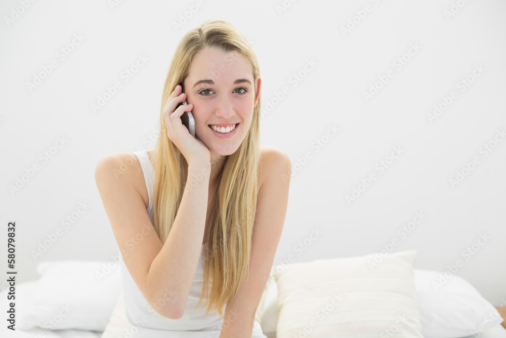Attractive young woman phoning with her smartphone smiling at ca Attractive young woman phoning with her smartphone smiling at ca