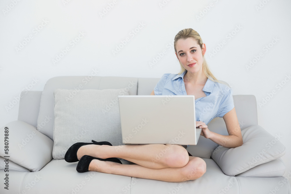 Attractive blonde businesswoman sitting on couch Attractive blonde businesswoman sitting on couch