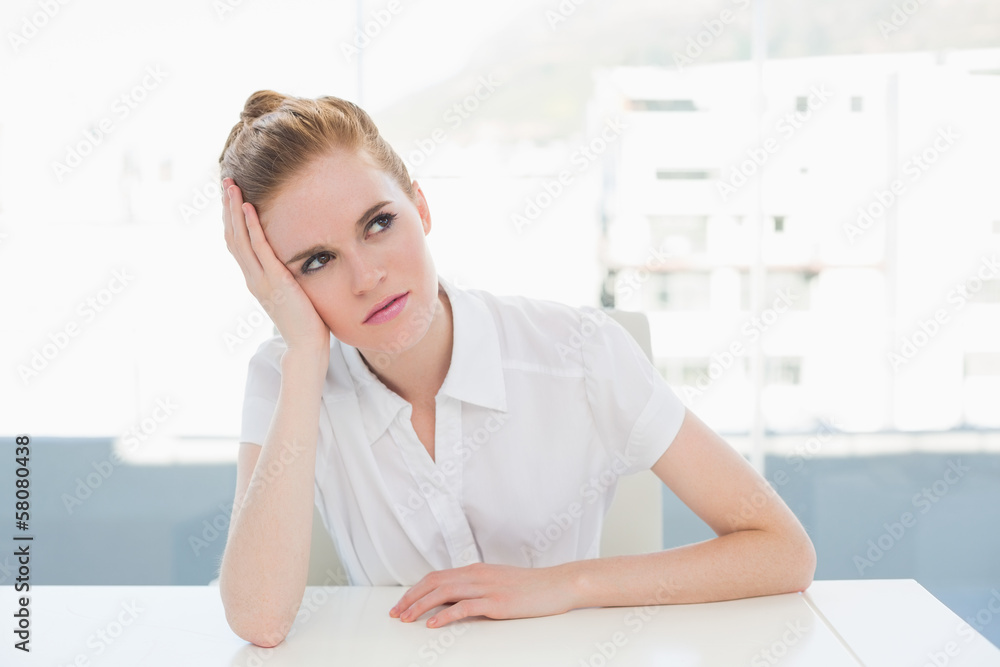 Thoughtful businesswoman looking away at office Thoughtful businesswoman looking away at office