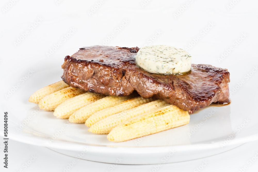 Delicious beef steak on white plate with corn Delicious beef steak on white plate with corn