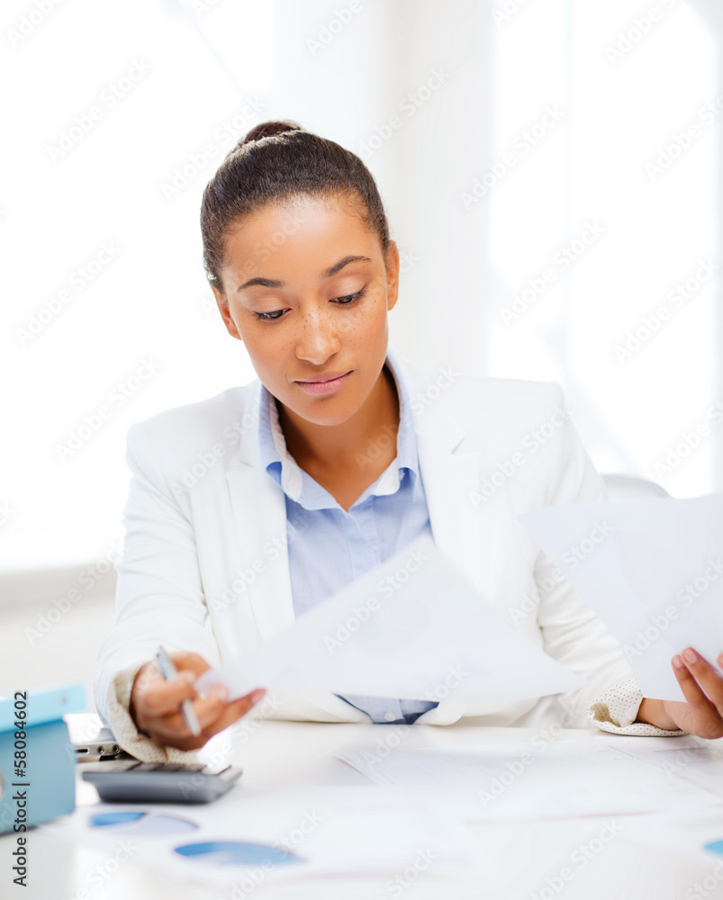 businesswoman working with calculator in office businesswoman working with calculator in office