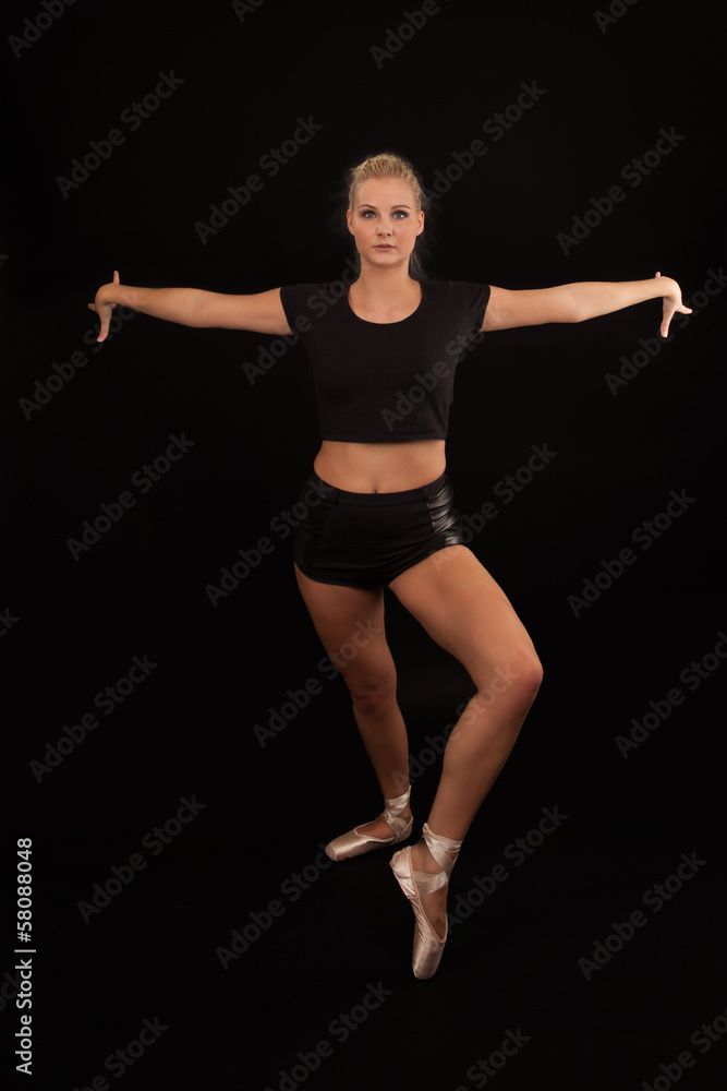 Obraz premium Dark studio portrait of a ballerina working out