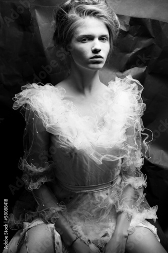 Portrait of a queen like young woman in white trashy dress