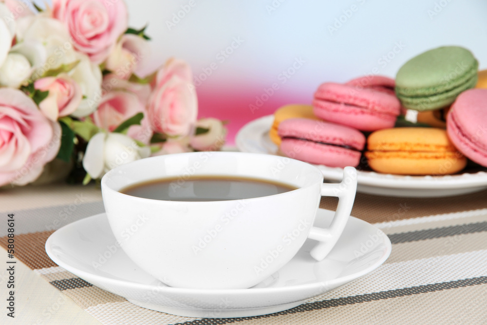Coffee and macaroons on table on light background Coffee and macaroons on table on light background