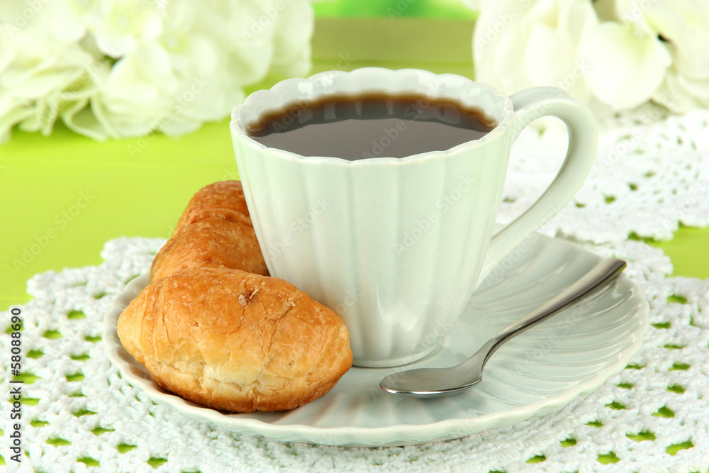 Tasty croissants and cup of coffee on table close-up Tasty croissants and cup of coffee on table close-up