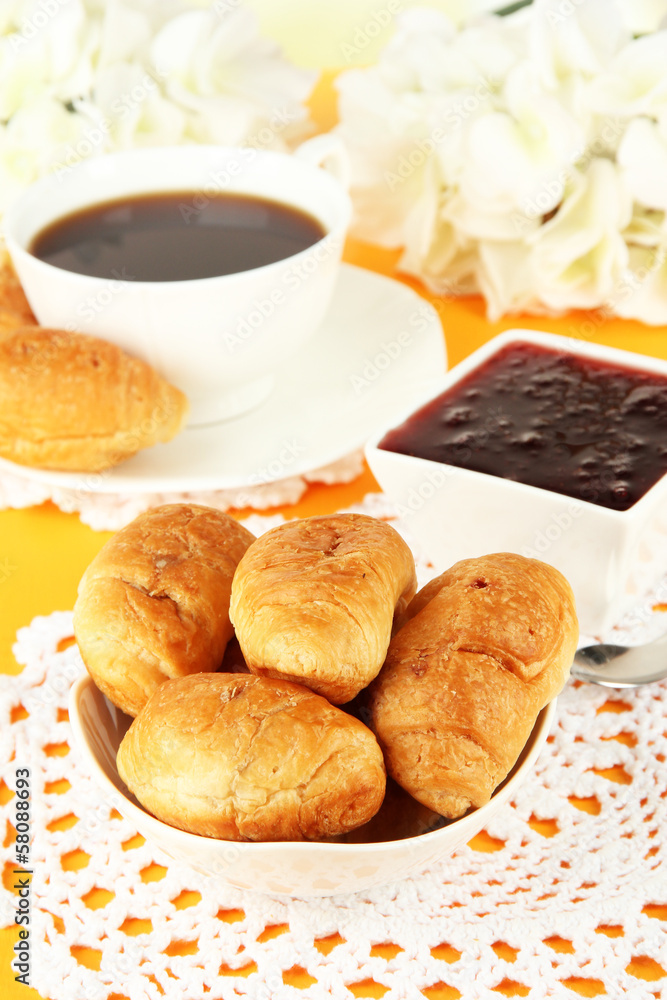 Tasty croissants and cup of coffee on table close-up Tasty croissants and cup of coffee on table close-up