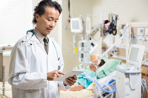 Doctor Examining Patient s Report On Digital Tablet