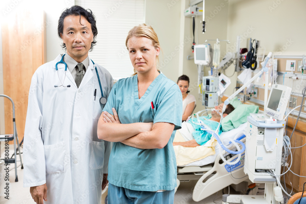 Confident Doctor And Nurse With Patient Resting In Hospital Confident Doctor And Nurse With Patient Resting In Hospital