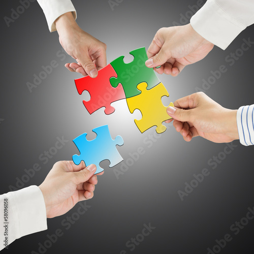 Team work concept  Hands hold puzzles connect each other with gr