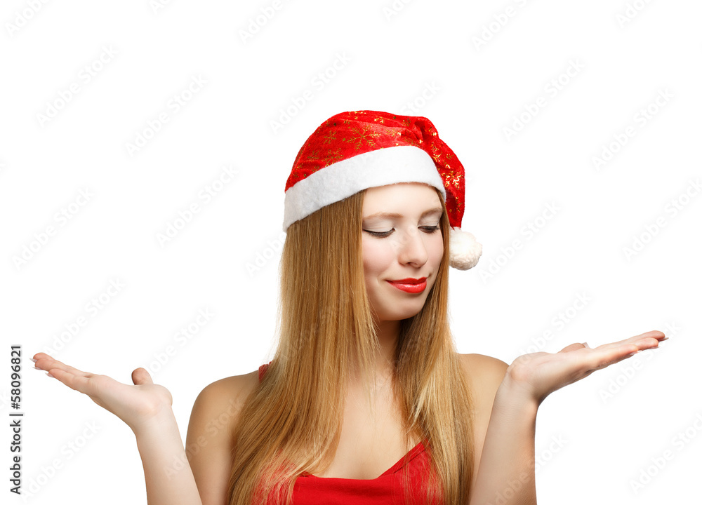 Young woman in santa hat with open hands Young woman in santa hat with open hands
