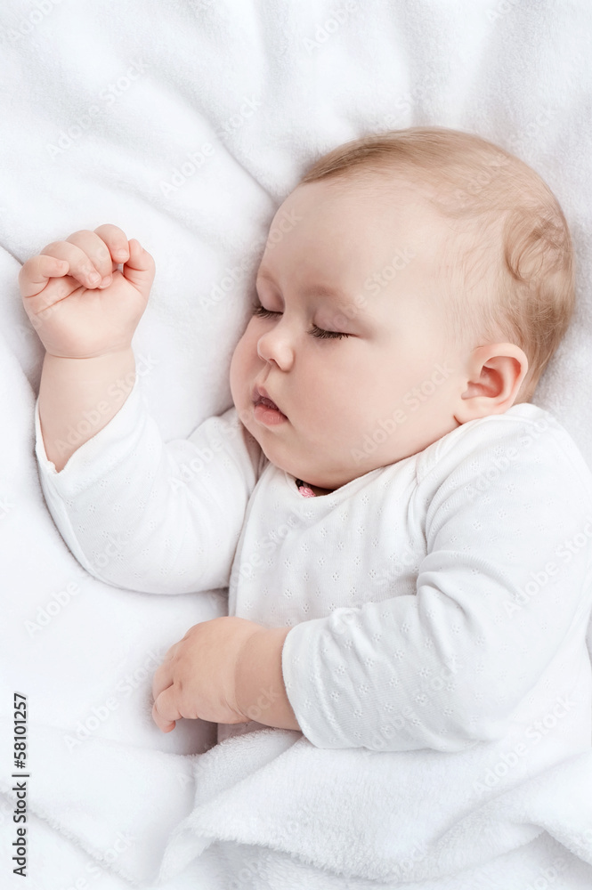 Carefree sleeping little baby on a bed