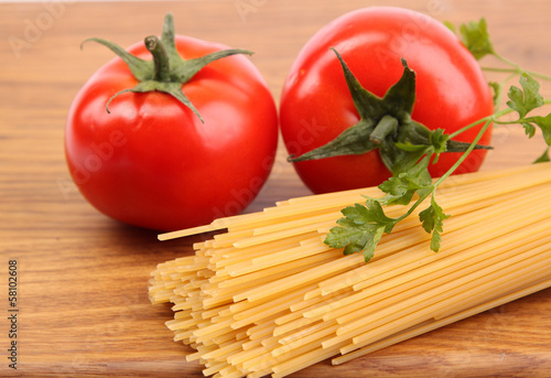 Spaghetti and tomatoes on board.