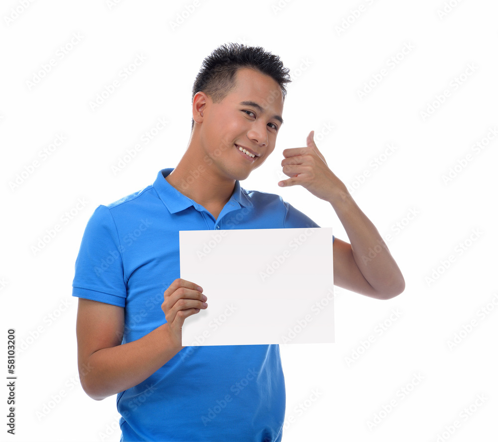 Young man holding blank billboard