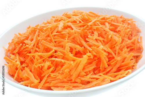 Raw grated carrots on a plate
