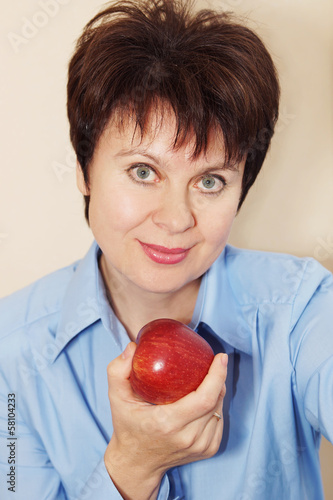 Portrait of a nice woman with an apple