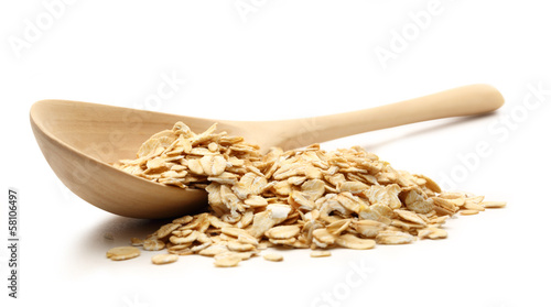 Heap of rolled oats with wooden spoon photo