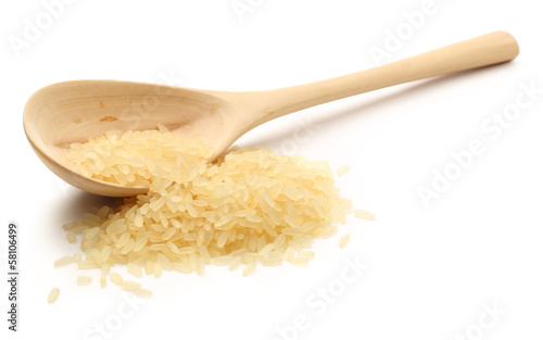 Heap of rice with wooden spoon