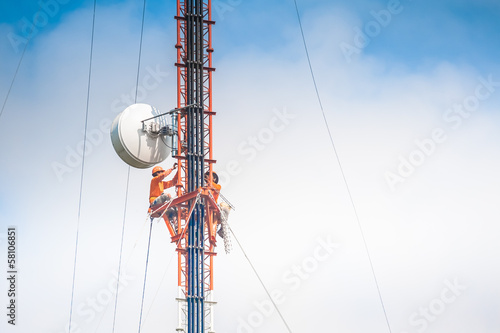Tower climber and working on cellular tower system.