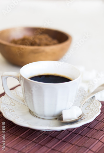 Cup of coffee with white and brown sugar