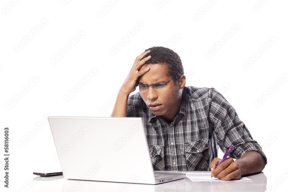 unhappy young black man writes data from his laptop unhappy young black man writes data from his laptop