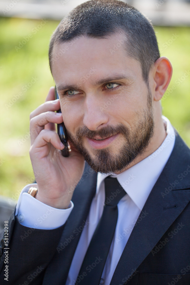 Handsome young businessman with a mobile phone Handsome young businessman with a mobile phone