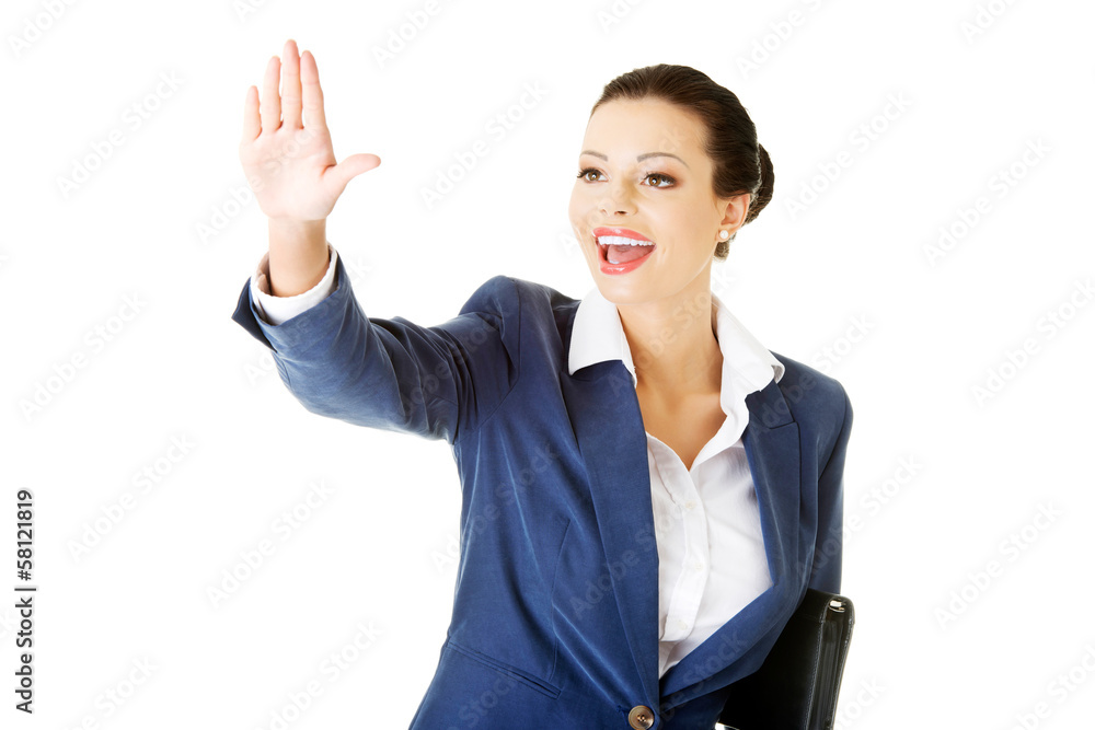 Attractive business woman with hand up looking. Attractive business woman with hand up looking.