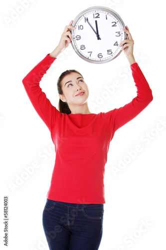 Fotografie Attractive young woman holding a clock.