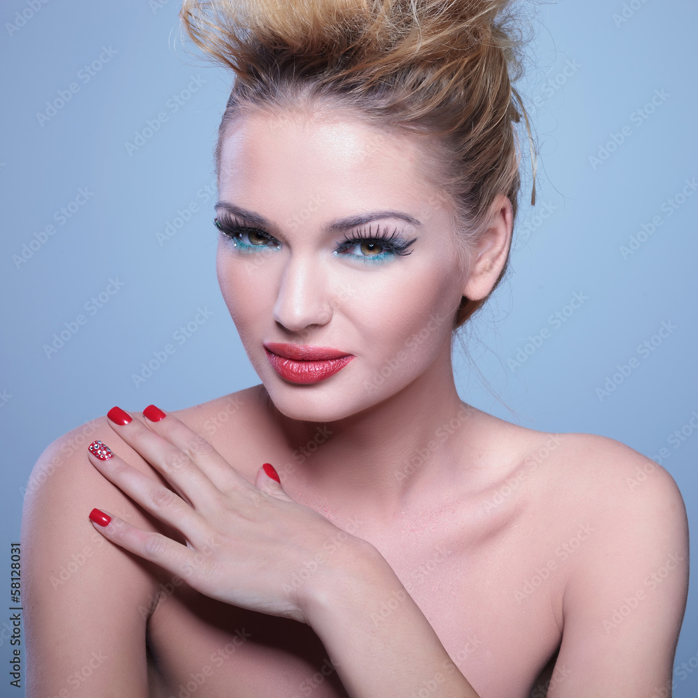 Fototapeta premium woman with great makeup and hairstyle with her hand on shoulder
